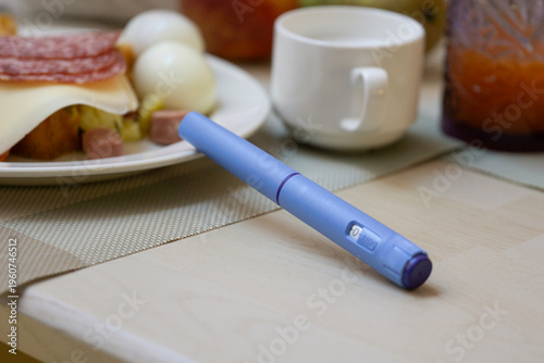 Canvastavla ozempic pen semaglutide injection blue medical device on wooden table with healt