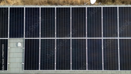 photovoltaic PV solar array installed on a tiled roof. residential or small-scale commercial renewable energy. monocrystalline panels black color more efficient and perform better in low-light conditi