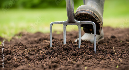 Gardener using garden fork to aerate soil, outdoor horticulture and earth care