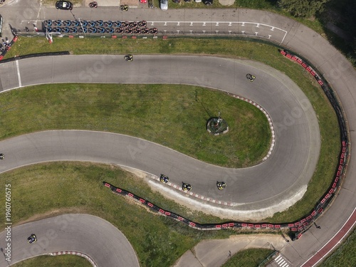 Canvastavla Go-Kart Track Race: An aerial view captures the dynamic energy of a go-kart race on a winding track, with small vehicles navigating sharp turns and grassy surroundings