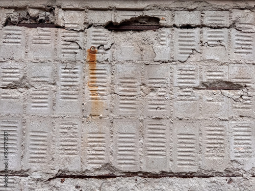 Fotografie Damaged concrete wall with rust stains cracks and exposed deteriorating surface