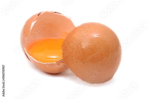 Natural fresh uncooked raw broken egg with eggshell closed up isolated on white 