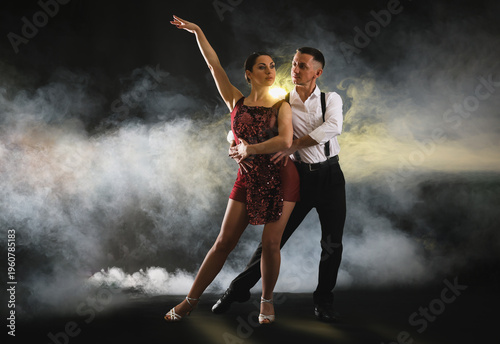 Obraz na płótnie Couple of professional dancers on dark background with smoke