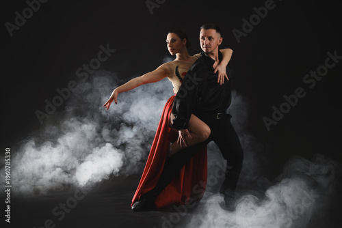 Tableau sur toile Couple of professional dancers on dark background with smoke