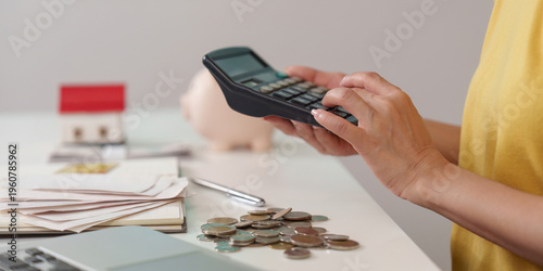 Calculating savings and financial planning with coins and calculator