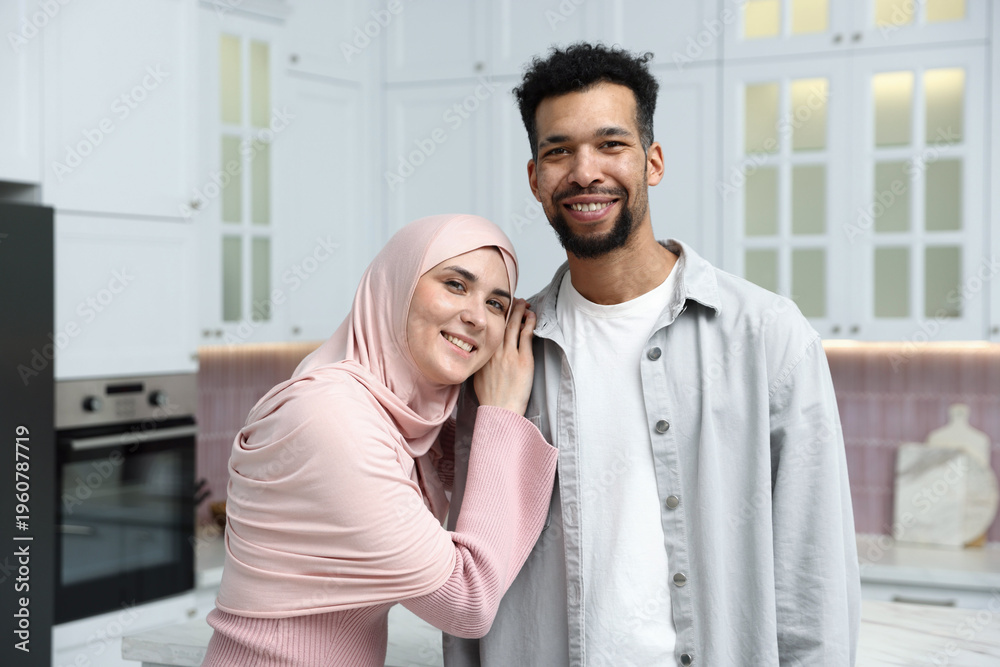 Fototapeta premium Portrait of happy muslim couple in kitchen