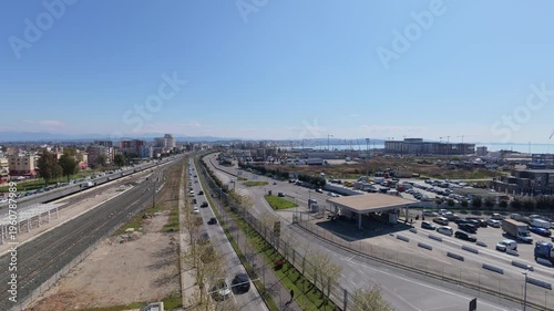 Elevated view of intense road traffic near the port of Durres, Albania. Urban infrastructure, busy transportation hub, cars and trucks moving along coastal roads, logistics and trade activity