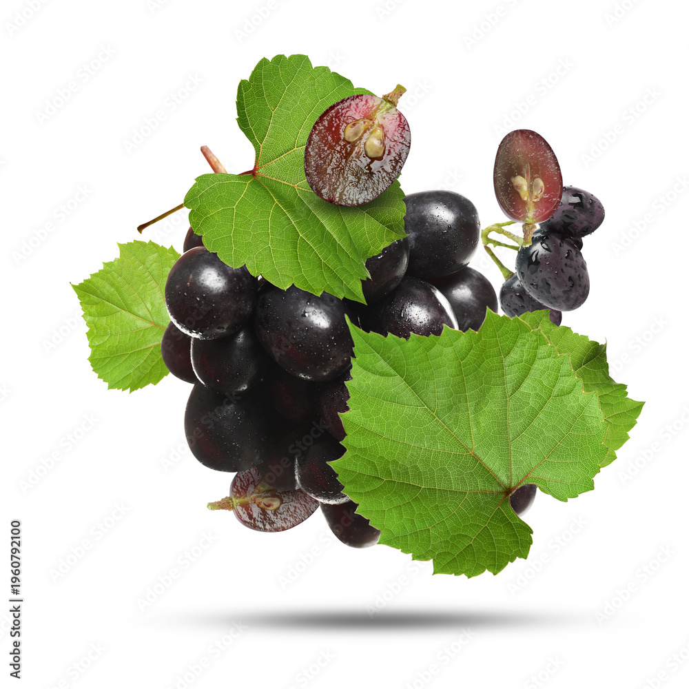 Obraz premium Fresh juicy grapes and green leaves falling against white background