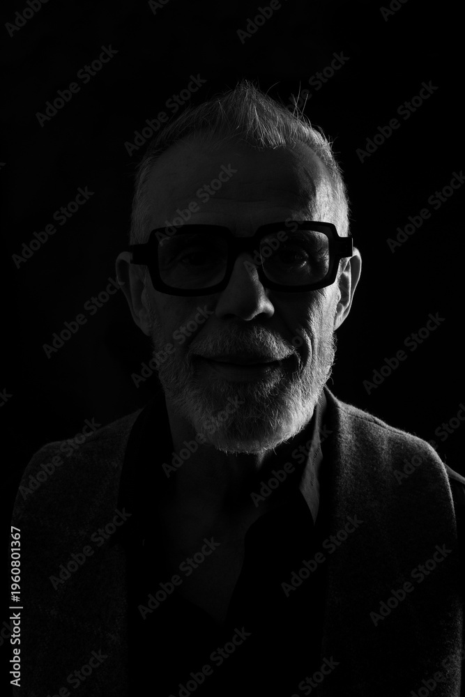 Fototapeta premium head shot dark portrait of a mature man looking at camera