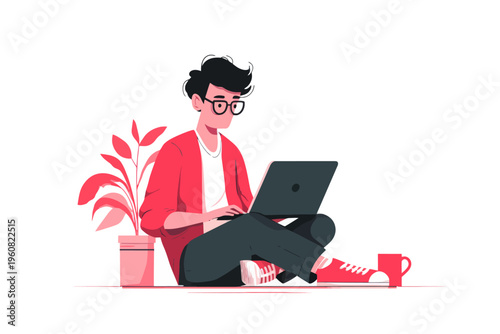 Young male working on laptop with red accents and plant
