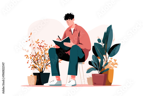 Young adult asian male sketching in notebook surrounded by potted plants