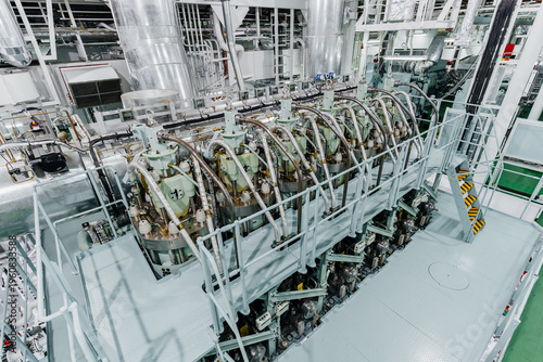 Fotografie High angle interior view of a massive marine diesel engine inside a ship engine