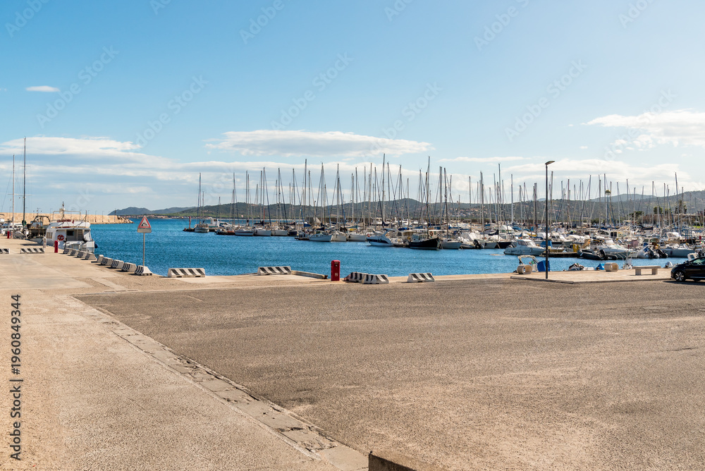Obraz premium La Caletta harbor in the municipality of Posada, one of the main tourist marinas on the eastern coast of Sardinia, Italy. Mediterranean port with boats and coastal scenery.
