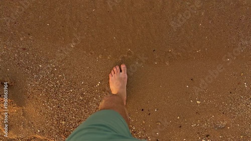 Walking By Shoreline. Casual Stroll On Sandy Beach. Leisurely Walk Along Wet Sandy Coast