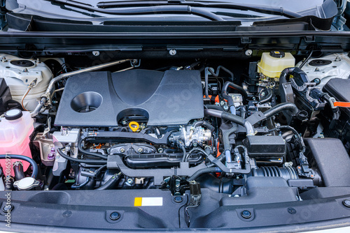 Fotografie Modern hybrid vehicle engine compartment with detailed components and wiring