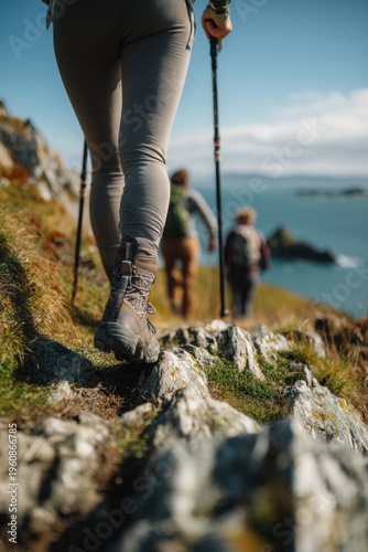 Wallpaper Mural Explore adventure outdoor in National Park. A person hiking on a rocky trail, wearing hiking boots and holding trekking poles. The ground is covered with grass and rocks. Torontodigital.ca