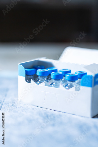 Sterile vials on clean table. Detailed shot of vaccine containers with clinical setting
