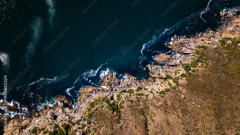 Obraz premium Aerial view of rocky coastline and ocean waves Cape Town