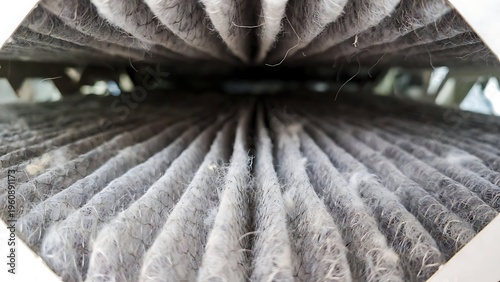 furnace, filter, air, technician, hvac. Close-up image of a heavily dust-clogged air filter showing accumulated fibers and dirt in a vehicle or HVAC system.