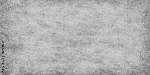 A dark and aged grey grunge paper texture featuring a rough, dirty surface pattern with a vintage charcoal cement backdrop for a textured stone or metal wallpaper design