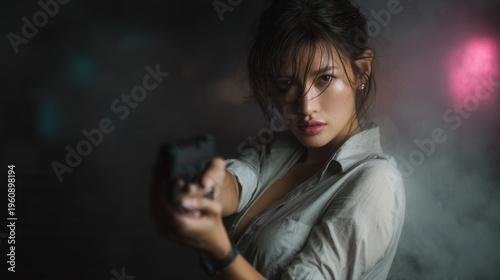 young Asian girl holding a pistol gun