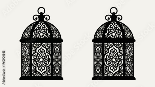 Two identical black ornate lanterns with intricate geometric patterns, resembling Moroccan or Arabic style decor.