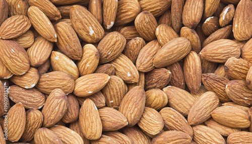Macro Photography of Densely Packed Raw Almonds Forming a Textured Background.