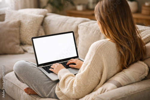 Woman Using Laptop on a Couch in a Cozy Living Room During Daytime
