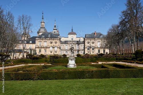 View of the formal gardens and the Royal Palace of La Granja de San Ildefonso in Segovia, Spain. Symmetrical Baroque landscape design, ornamental hedges and historic royal residence