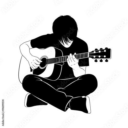 Young man playing acoustic guitar sitting.