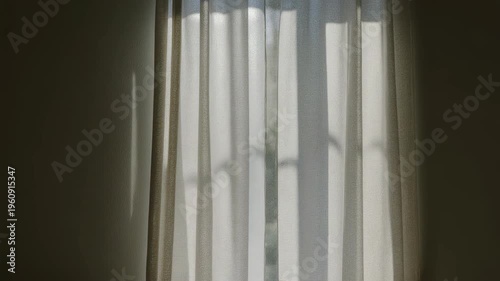 Close-up of striped gray curtain fabric with vertical lines and soft light texture pattern