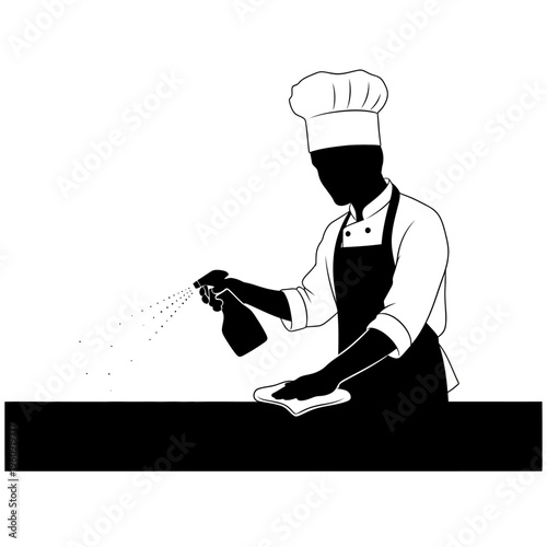 Chef spraying cleaning solution on surface.