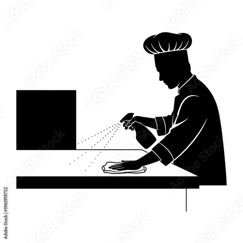 Chef spraying seasoning on food.