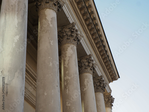 Low angle view of weathered neoclassical columns and facade of a Warsaw building