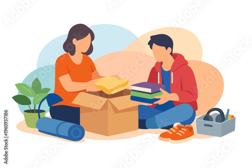 Couple packing items into a cardboard box for moving or donation.
