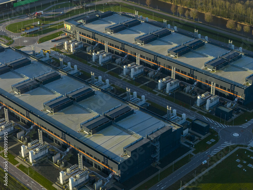 Aerial view of large server farms hosting information technology infrastructure and cloud computing ai services. Modern facility for digital data storage, Middenmeer, Netherlands.