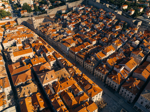 Aerial view of a sea of terracotta rooftops cascading down the ancient city, framed by imposing stone walls, Dubrovnik, Dubrovnik-Neretva County, Croatia.