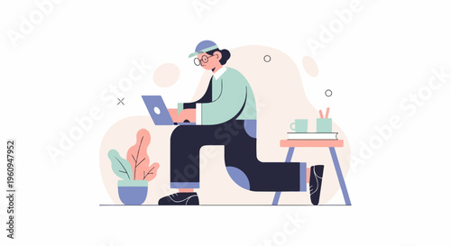 Person in cap and glasses works on laptop with plant, desk, and cup nearby