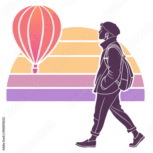 A man walking with a backpack looking at a hot air balloon