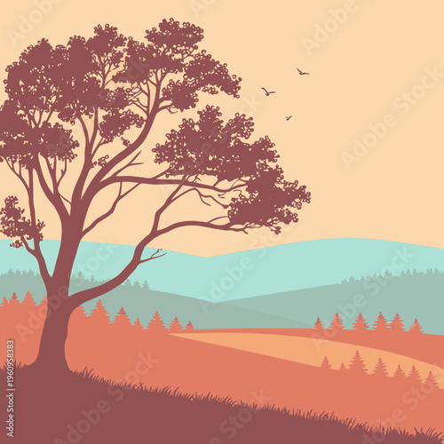 A large tree on a hill with mountains in the background