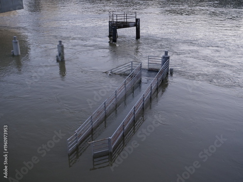 Paris, France - February 25, 2026. A close-up of the Seine River and some metallic structures during the flood in winter.