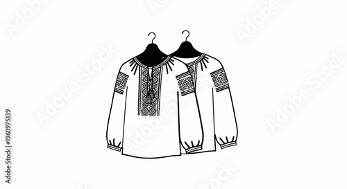 Two intricately embroidered folk blouses with tassel detail hang