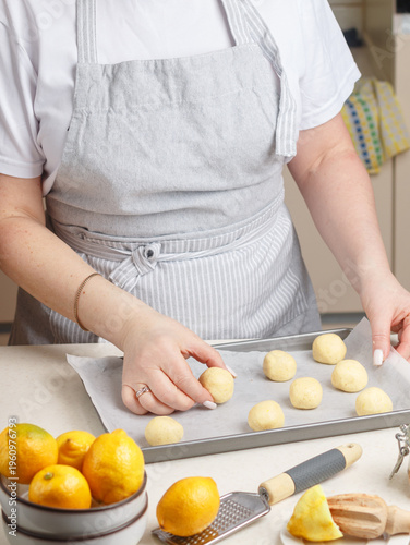 Woman in the kitchen prepares lemon cookies. Fresh homemade pastries. Selective focus