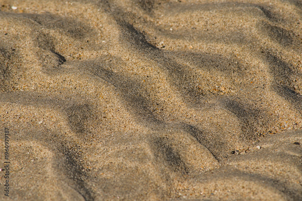 Fototapeta premium r ippling patterns created by movement of water and wind in the sand of the beach 
