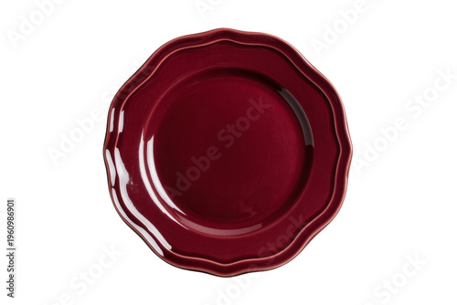 Isolated glossy maroon ceramic dinner plate with elegant scalloped edge and reflections
