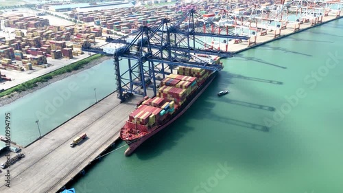 Stunning Aerial view of container ship at Port of Tanjung Pelepas Johor Malaysia. maritime operations, featuring giant gantry cranes and vast container yards