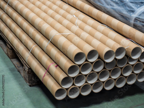 Fotografie Industrial warehouse scene featuring multiple long cylindrical cardboard postal