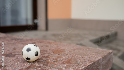 Fotografía Small soccer ball on stone step in urban setting