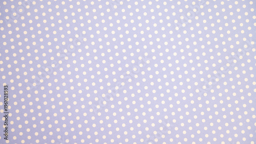 Pastel purple polka dot pattern with white dots on fabric background