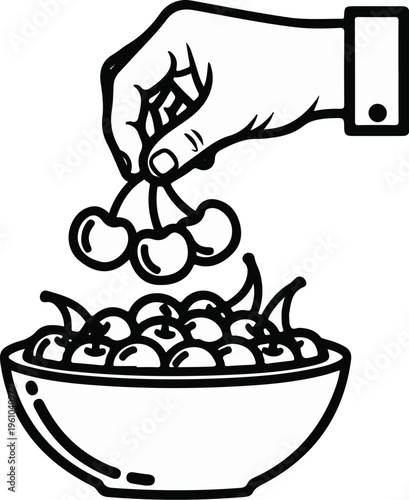 A hand places cherries from a bunch into a bowl overflowing with more cherries